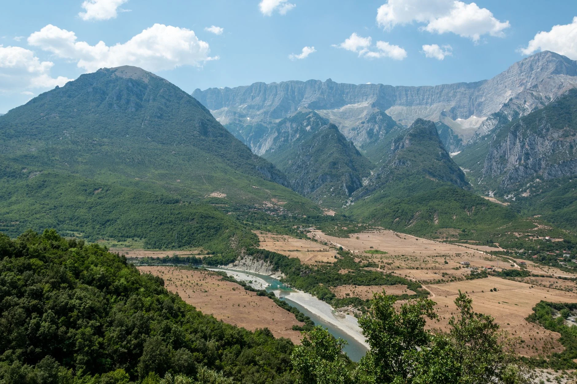 Vista aérea del valle de Përmet, con vegetación y montañas en Albania.